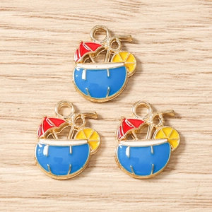 Detail view of three blue enamel tropical cocktail charms with red umbrella for DIY jewelry