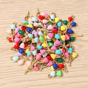 Close-up of heart-shaped balloon alloy charms with colorful enamel finish for DIY jewelry