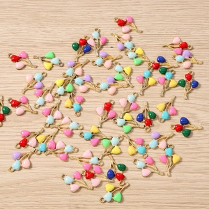 Detail of colorful enamel heart balloon charms with gold plating for DIY jewelry making