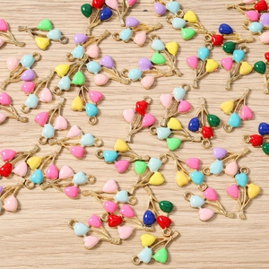 Macro shot of colorful enamel balloon charms with gold alloy bases for DIY jewelry making