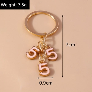 Detailed view of pink enamel number 5 pendants with golden keyring and size measurements