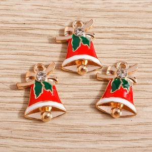 Detailed view of red and green enamel Christmas bell charms with crystals and golden bows