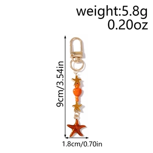 Detailed view of sea star keychain with size markers 9cm length and 1.8cm width