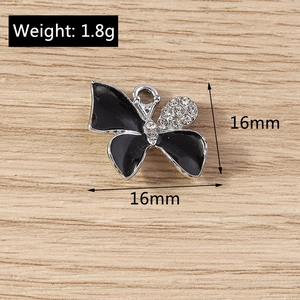 Detail of 16mm black enamel butterfly pendant with silver finish and rhinestone inlay