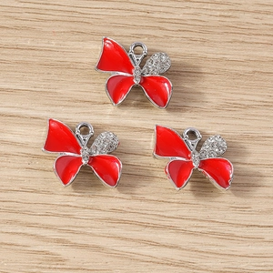 Detailed view of red enamel butterfly charms with sparkling rhinestones for DIY jewelry