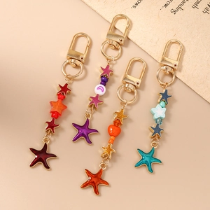 Chic set of four colorful starfish keychains with gold lobster clasps and enamel charms
