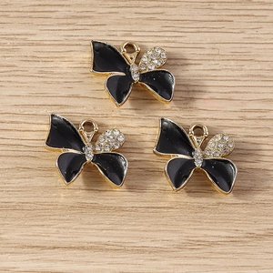 Detailed macro view of three black butterfly pendants with gold edges and tiny crystals