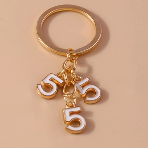 Golden keychain with three white enamel number five charms and polished metal ring
