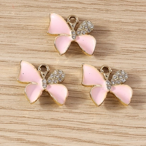 Detailed view of handmade enamel butterfly pendants with sparkling white rhinestones