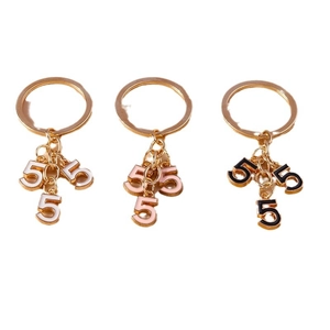 Golden keychain set with creative oil-dripped number 5 charms in black, pink and white