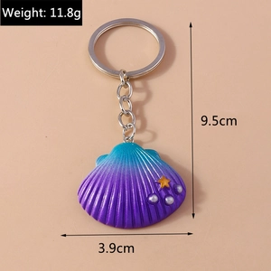 Detailed view of seashell keychain with blue-purple gradient and white pearl accents