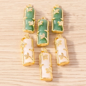 Bamboo shaped jade style resin pendants with golden metal leaf accents in green and white