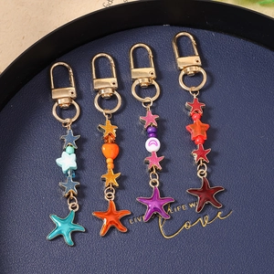 Charming enamel starfish keychains in blue, orange, purple and red with gold metal clips