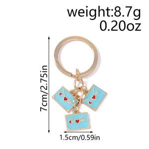 Macro view of blue enamel heart envelopes and dimensions for the keychain accessory