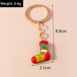Detailed view of a Christmas boot keychain with golden sequins and size specifications