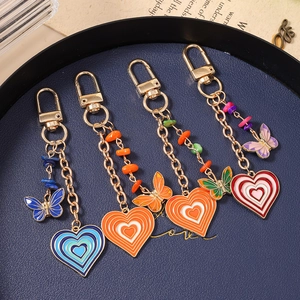 Set of four colorful butterfly heart keychains with enamel pendants and gold lobster clips