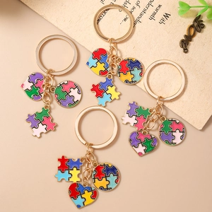Set di quattro portachiavi a cuore con puzzle colorati e anelli dorati su sfondo chic