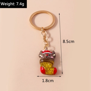 Detail of Christmas reindeer keychain featuring dimensions and gold glitter stocking charm