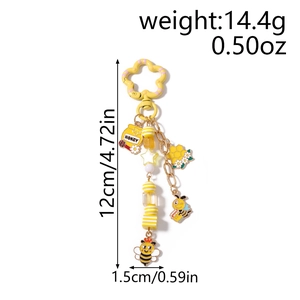 Détail du porte-clés abeille avec pot de miel, étoiles et perles montrant la mesure de 12cm