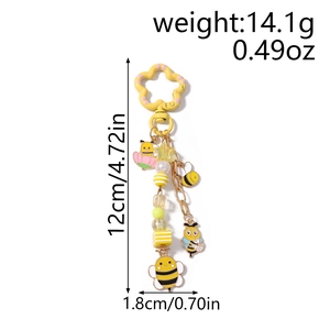 Vue détaillée du porte-clés abeille perlé jaune avec étiquettes de taille et de poids
