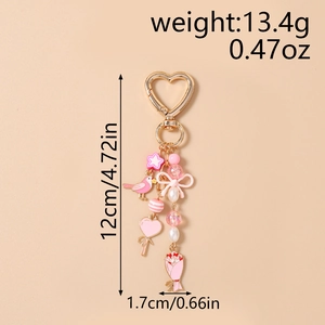 Pink beaded keychain with bird and bow pendants showing dimensions 12cm length and 1.7cm width