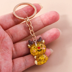 Close-up of cute reindeer keychain with gold sequins inside and rose gold metal ring