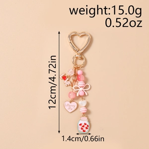 Detail view of heart charm keychain with size info, pink bow and love jar charm