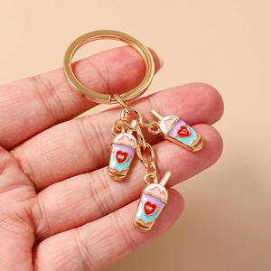Fashionable heart milk tea keychain with three colorful enamel pendants in gold finish