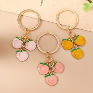 Fashionable peach fruit keychain with pink enamel charms and gold metal ring for bags