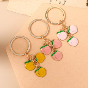 Fashionable peach enamel keychains with gold metal rings in yellow and pink shades