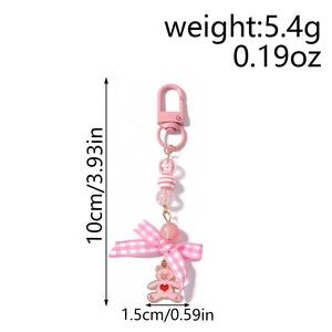Pink bear keychain featuring beaded strap, plaid bow, and detailed product measurements