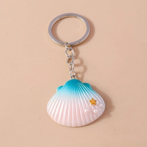 Shell keychain with blue pink gradient resin, faux pearls and golden star charms