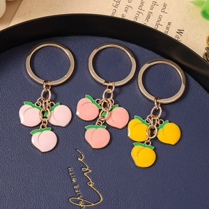 Chic peach enamel keychains with gold metal rings in pink, orange, and yellow hues