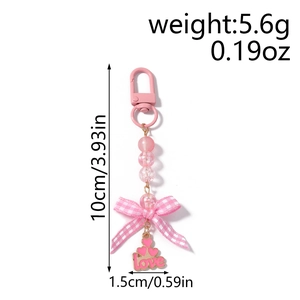 Detailed view of pink beaded keychain with fabric bow and love heart charm measurements