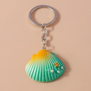 Shell shaped keychain with yellow-green gradient and star accents on beige background