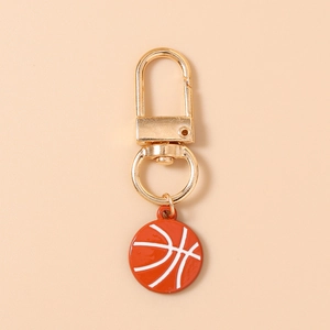 Detailed view of an orange basketball keychain with a gold metal clasp and white lines