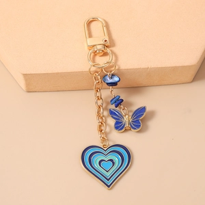 Detail of blue heart keychain with enamel butterfly pendant and gold lobster clasp
