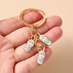 Detail of cute bubble tea keychain with heart charms and golden ring accessory