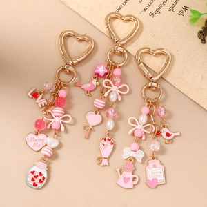 Pink beaded bird bouquet keychain with heart charms and romantic valentine bottle tag