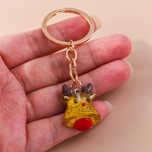 Detailed view of a cute reindeer bell keychain with glittery finish and red nose