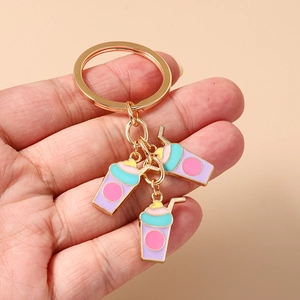 Detailed view of golden heart milk tea keychain with colorful enamel drink charms