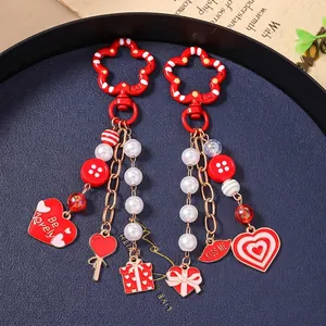 Fashionable beaded lip keychain set with heart pendants and red flower hooks on deep blue tray
