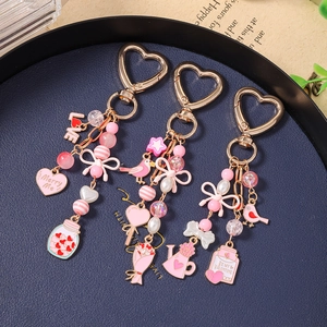 Pink heart and bird charm keychains with gold finish for Valentine gifts
