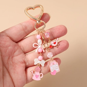 Macro shot of pink enamel charms with Be My Valentine text and heart-shaped hook