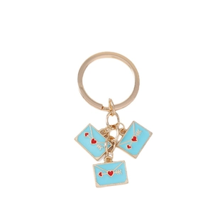 Golden keychain featuring three blue envelope charms with red heart and arrow motifs