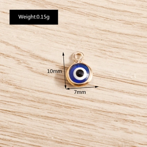 Macro shot of blue evil eye charm with gold plating showing 10mm x 7mm dimensions