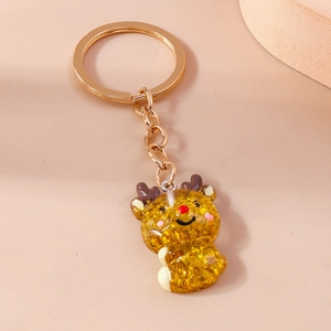 Close-up of a cartoon reindeer keychain with golden glitter fill and metallic ring
