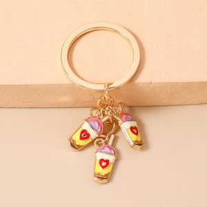 Detail of metal keychain with three heart milk tea charms in yellow pink and purple