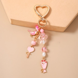 Pink bird and floral heart-shaped keychain with beads and elegant bow detail