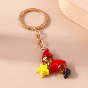 Close-up of Christmas gnome keychain with red hat and gold glitter beard detail